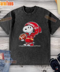 Snoopy wearing a Kansas City Chiefs hoodie, smiling at fans in a washed t-shirt, celebrating team spirit.