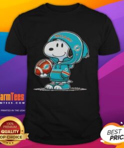 Alt Text: Snoopy in a Miami Dolphins hoodie smiles at fans on a vibrant t-shirt featuring Awesome Peanuts design.