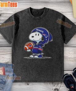 Snoopy in a New England Patriots hoodie smiles at fans on a washed t-shirt, showcasing awesome peanuts-themed design.
