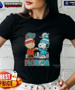 Adorable Charlie Brown and Snoopy graphic on a Florida Gators and Miami Dolphins skyline ladies tee.