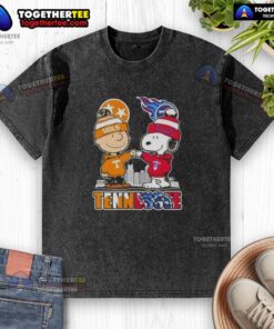 Alt Text: Cute Charlie Brown and Snoopy in Tennessee Vols x Titans skyline design on a washed t-shirt, perfect for fans.