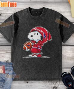 Alt Text: Cute Peanuts Snoopy in a Houston Texans hoodie, smiling at fans, featured on a washed t-shirt design.