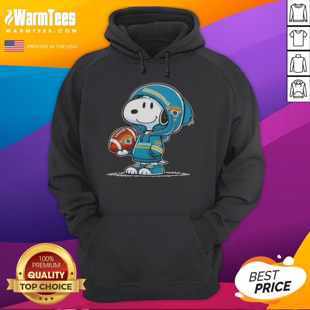 cute-peanuts-snoopy-wearing-hoodie-jacksonville-jaguars-and-smilling-at-fans-hoodie Alt Text: Cute Peanuts Snoopy wearing a Jacksonville Jaguars hoodie, smiling at fans with a cheerful expression.