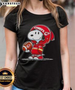 Cute Snoopy in a Kansas City Chiefs hoodie smiles at fans on a ladies tee, perfect for Chiefs supporters.
