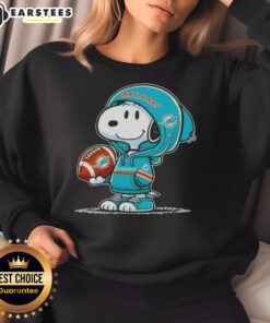 Cute Peanuts Snoopy wearing Miami Dolphins hoodie, smiling at fans in a colorful sweatshirt.