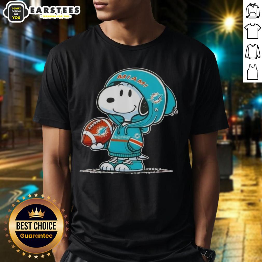 cute-peanuts-snoopy-wearing-hoodie-miami-dolphins-and-smilling-at-fans-t-shirt Alt Text: Cute Peanuts Snoopy in a Miami Dolphins hoodie, smiling at fans on a fun graphic T-shirt design.