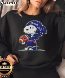 Alt Text: Cute Peanuts Snoopy in a New England Patriots hoodie, smiling at fans while wearing a cozy sweatshirt.