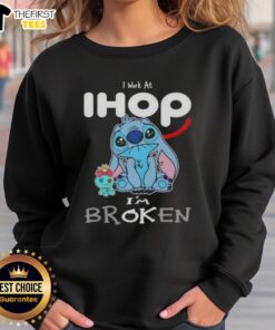 Cute Stitch sweatshirt with 'I work at IHOP, I'm broken' design, perfect for fans of Disney and cozy fashion.