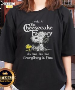 Alt Text: Cute Snoopy and Woodstock graphic on a ladies tee with I work at the Cheesecake Factory, it's fine text.