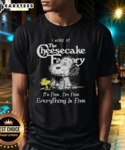Alt Text: Funny tired Snoopy and Woodstock graphic on a t-shirt saying 'I work at The Cheesecake Factory, it's fine'.