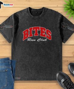 Good Bites Run Club Volume 2 washed t-shirt displayed on a wooden surface, showcasing its casual style and comfort.
