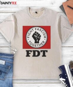 Alt Text: Good Fight Fascism Together logo on a washed t-shirt, promoting unity and activism against fascism.
