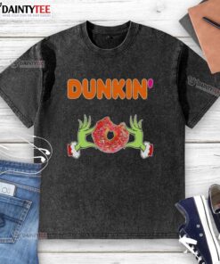 Good Grinch hands holding a Dunkin' donut on a Merry Christmas washed t-shirt, perfect for holiday cheer.