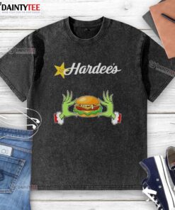 Good Grinch hands on a washed t-shirt, showcasing love for Hardee's this Merry Christmas in a festive design.