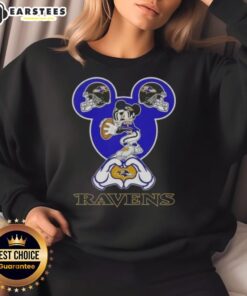 Good Mickey hands forming a heart on a Baltimore Ravens football sweatshirt, perfect for fans showing love for their team.