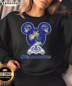 Good Mickey hands forming a heart in a Seattle Seahawks football sweatshirt, showcasing team spirit and love for football.