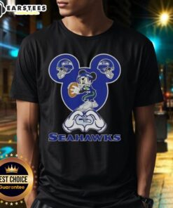 Good Mickey hands forming a heart on a Seattle Seahawks football T-shirt, perfect for fans showing love for their team.