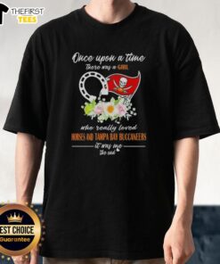 Alt Text: Girl wearing 'Once Upon A Time' T-shirt featuring horses and Tampa Bay Buccaneers logo, showcasing her love for both.