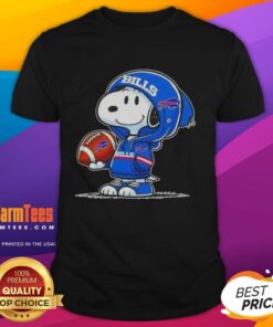 Alt Text: Snoopy in a hoodie smiling at fans on a 'Good Peanuts' T-shirt featuring the Buffalo Bills logo.