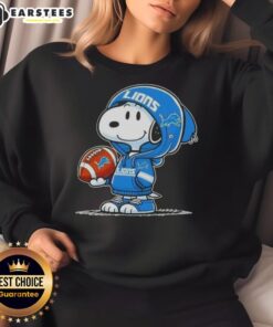 Alt Text: Snoopy wearing a Detroit Lions hoodie smiles at fans, showcasing the Good Peanuts sweatshirt design.