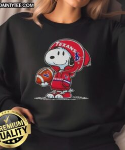 Alt Text: Happy Peanuts Snoopy wearing a Houston Texans hoodie, smiling at fans while showcasing his stylish sweatshirt.