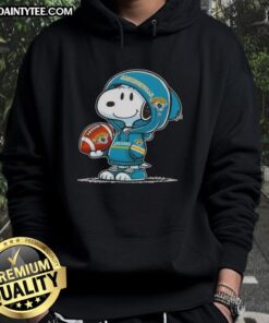 Happy Peanuts Snoopy in a Jacksonville Jaguars hoodie, smiling at fans at a football event.