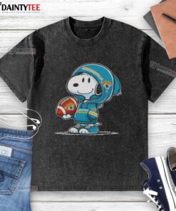 Happy Peanuts Snoopy wearing Jacksonville Jaguars hoodie, smiling at fans, showcasing a washed t-shirt design.