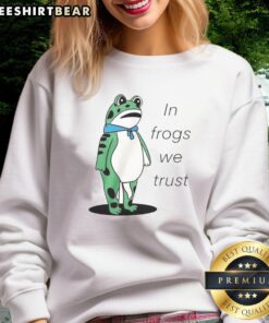 Happy Portland frog wearing 'In Frogs We Trust' sweatshirt, showcasing vibrant colors and playful design.