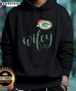 Happy Wifey in a Green Bay Packers Santa hat and Merry Christmas hoodie, celebrating the holiday season in style.