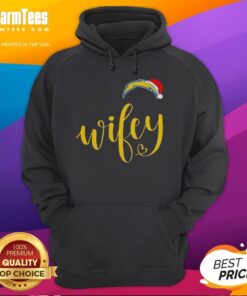 Happy woman in a Los Angeles Chargers hoodie and Santa hat, celebrating Merry Christmas with festive cheer.