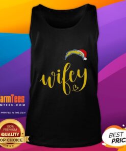 Happy Wifey wearing a Los Angeles Chargers tank top and Santa hat, celebrating Christmas with festive cheer.