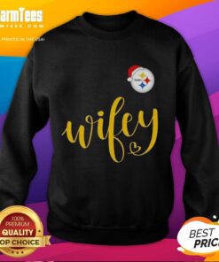 Happy wifey in a Pittsburgh Steelers sweatshirt and Santa hat, celebrating Merry Christmas cheerfully.