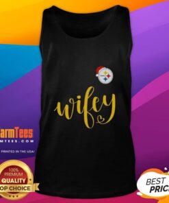 Happy Wifey in a Pittsburgh Steelers tank top wearing a Santa hat, celebrating Christmas cheerfully.