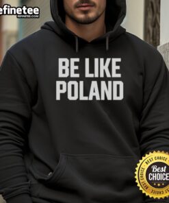 Man wearing a Hot Tommy Robinson Be Like Poland hoodie, showcasing a bold graphic and vibrant colors.