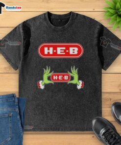 Festive Grinch hands holding a heart on an H-E-B Christmas washed t-shirt, perfect for holiday cheer and seasonal style.