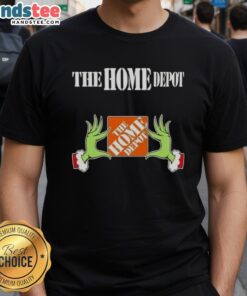 Nice Grinch hands holding a Home Depot Christmas T-shirt, perfect for festive holiday celebrations and gift giving.