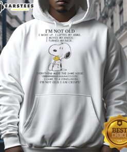 Nice Peanuts Snoopy hoodie featuring the phrase 'I'm Old, I Woke Up, I Lifted My Arms, I Moved My Knees' in vibrant colors.