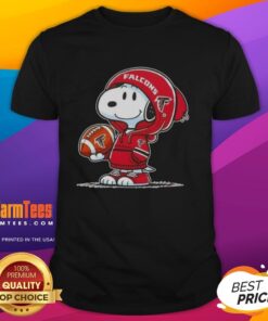 Alt Text: Peanuts Snoopy in a hoodie smiling at fans, showcasing Atlanta Falcons spirit on a T-shirt.