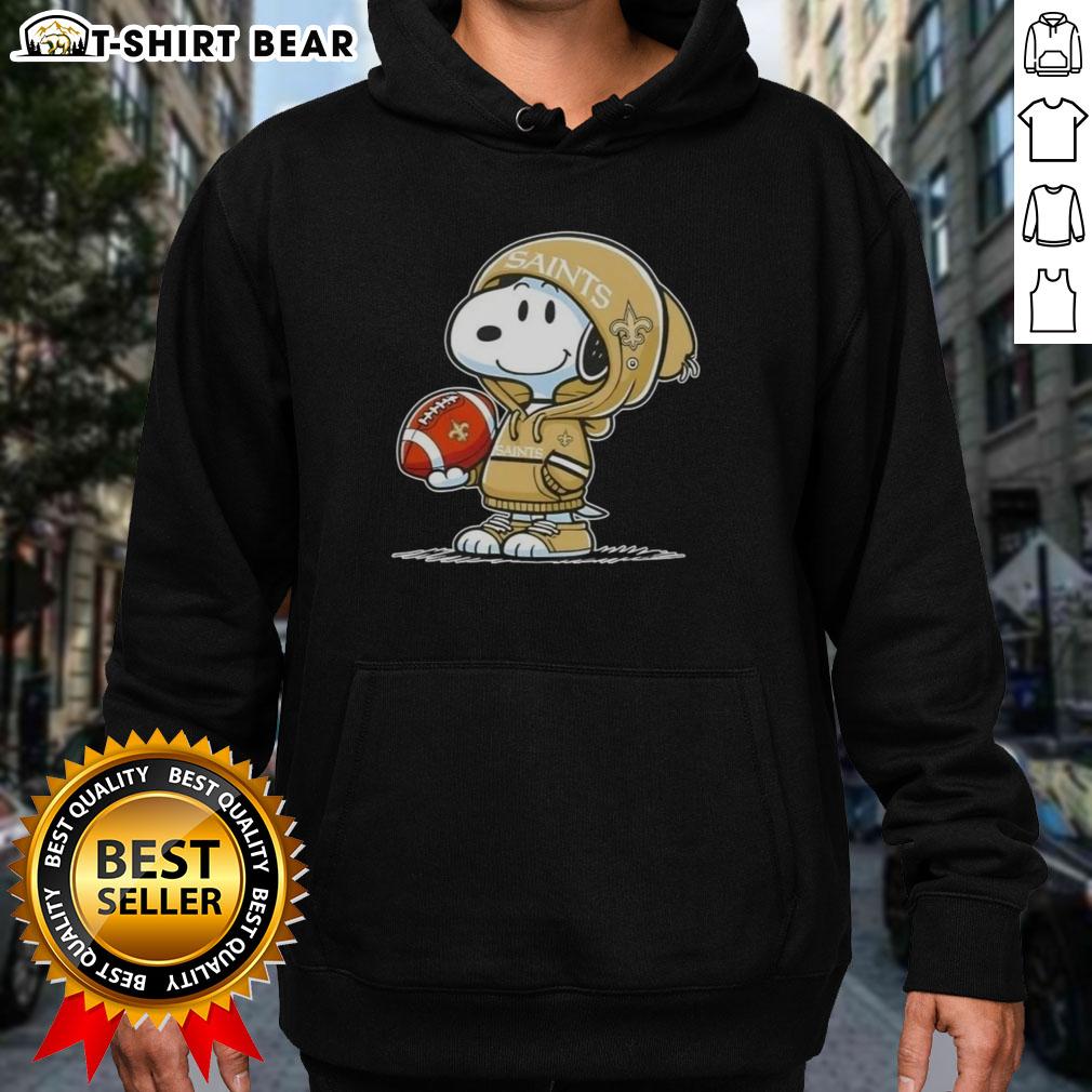 Official Peanuts Snoopy Wearing Hoodie New Orleans Saints And Smilling At Fans Hoodie Snoopy wearing a New Orleans Saints hoodie, smiling at fans, showcasing his official Peanuts merchandise.