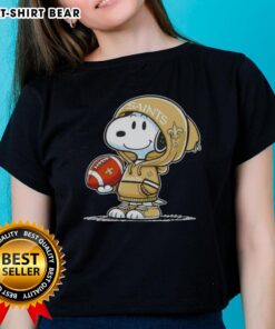 Snoopy in a hoodie, smiling at fans, showcasing the New Orleans Saints on a ladies tee - Official Peanuts design.