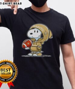 Alt Text: Snoopy in hoodie supporting New Orleans Saints, smiling at fans, featured on official Peanuts T-shirt design.