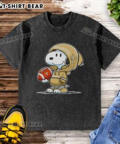 Alt Text: Snoopy in a hoodie, smiling at fans, showcasing the Official Peanuts New Orleans Saints washed t-shirt design.