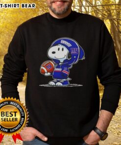 Snoopy in a New York Giants hoodie smiles at fans, showcasing the Official Peanuts sweatshirt design.