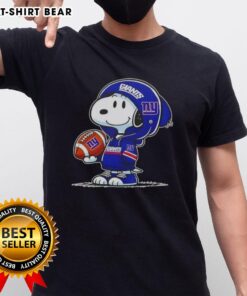 Alt Text: Snoopy in a New York Giants hoodie smiles at fans on a T-shirt, showcasing official Peanuts character design.