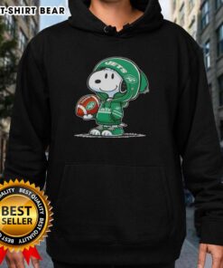 Alt Text: Snoopy in a New York Jets hoodie, smiling at fans, showcasing official Peanuts merchandise with team spirit.