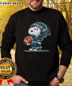 Alt Text: Snoopy in a hoodie smiling at fans, wearing Philadelphia Eagles sweatshirt, perfect for Peanuts fans and sports lovers.