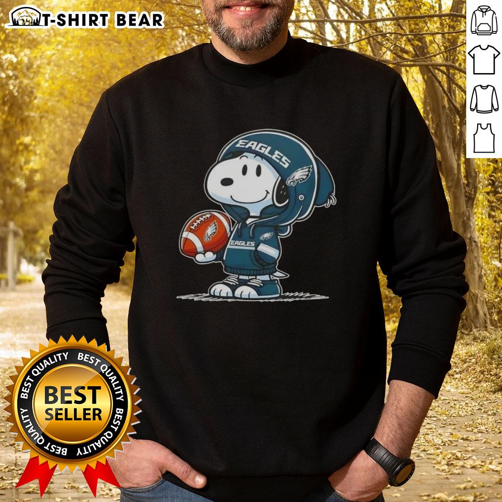 Official Peanuts Snoopy Wearing Hoodie Philadelphia Eagles And Smilling At Fans Sweatshirt Alt Text: Snoopy in a hoodie smiling at fans, wearing Philadelphia Eagles sweatshirt, perfect for Peanuts fans and sports lovers.