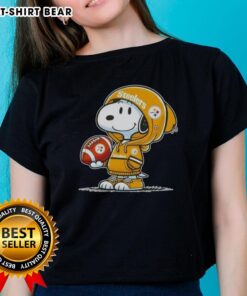 Snoopy wearing a Pittsburgh Steelers hoodie smiles at fans on a ladies tee, showcasing official Peanuts merchandise.