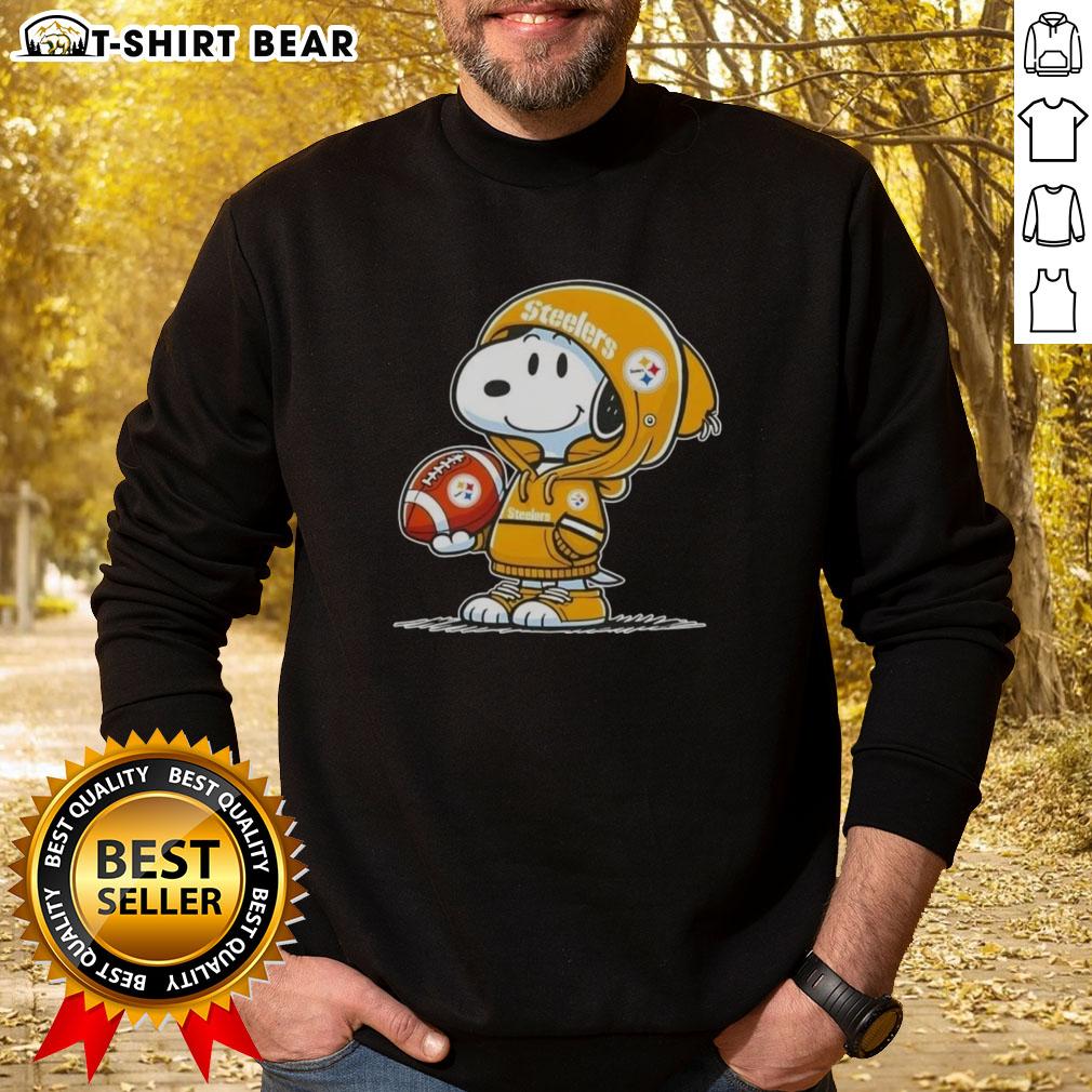 Official Peanuts Snoopy Wearing Hoodie Pittsburgh Steelers And Smilling At Fans Sweatshirt Snoopy wearing a Pittsburgh Steelers hoodie, smiling at fans in an official Peanuts sweatshirt.