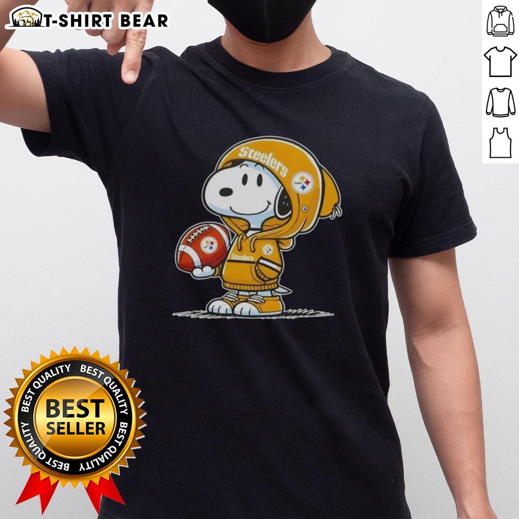 Official Peanuts Snoopy Wearing Hoodie Pittsburgh Steelers And Smilling At Fans T-Shirt Alt Text: Peanuts Snoopy in a hoodie, smiling at fans, wearing a Pittsburgh Steelers T-shirt, perfect for NFL enthusiasts.